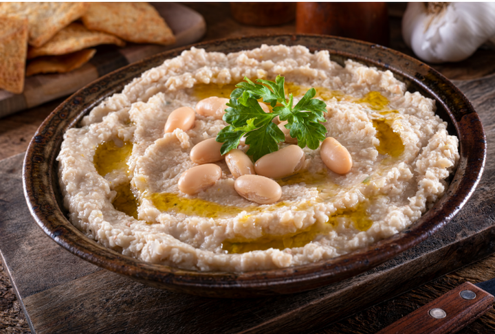 A bowl of haricot bean mash with olive oil drizzle